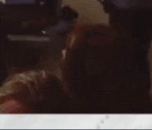 a woman is crying while sitting in front of a computer screen .