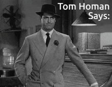 a man in a suit and hat with the words tom homan says behind him