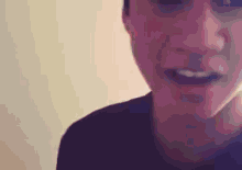 a close up of a person 's face with their mouth open and a purple background .