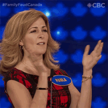 a woman wearing a name tag that says paula