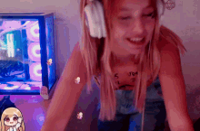 a girl wearing headphones has a tattoo on her arm that says ' jesus ' on it