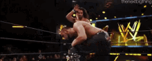 a blurry picture of wrestlers in a wrestling ring with the nextbigthing written in the corner