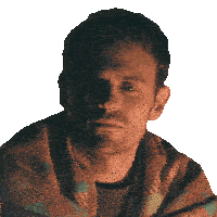 a man is wrapped in a plaid blanket and looking at the camera