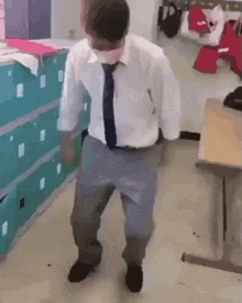 a man wearing a mask is dancing in a room .