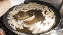 a pan of food is being cooked and the words made in animatica are visible