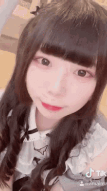 a close up of a girl 's face with a tik tok sticker on it
