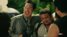 a group of men are laughing and one of them is wearing a name tag that says ' bul '