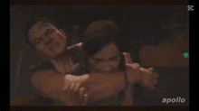 a woman is being held by a man and the word apollo is on the bottom