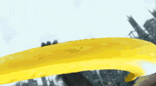 a yellow ribbon is flying in the air