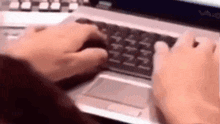 a person is typing on a laptop with a mouse and keyboard .