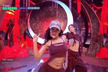 two women are dancing on a stage with the words " get ready to turn it on " in the corner