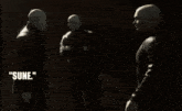 three men shaking hands with the words " how sune " behind them