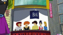 a group of people are standing in front of a sign that says bag tokyo books