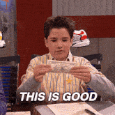 a boy in a striped shirt is holding a dollar bill and says " this is good " on the bottom