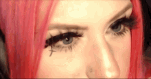 a close up of a woman 's face with red hair