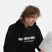 a man wearing a black hoodie that says pod with meg on it