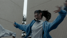 two girls wearing sweatshirts that say ucla are dancing