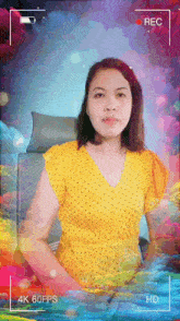 a woman in a yellow shirt is being recorded at 4k 60fps