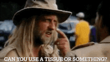 a man in a cowboy hat is talking to another man .