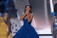 a woman in a blue dress with the word miss on the bottom left