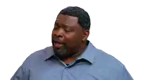 a man in a blue shirt is making a funny face with his mouth open