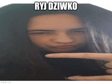 a girl making a funny face with ryj dziwko written above her