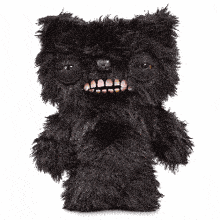 a black stuffed animal with teeth and a skull on its head