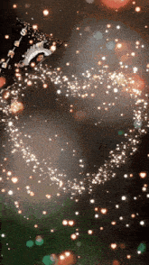 a christmas tree is surrounded by sparkles and hearts