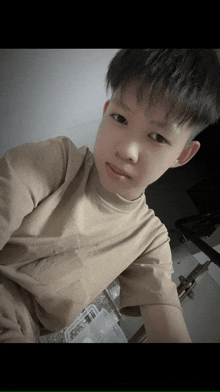 a young boy taking a selfie with a container of food in the background