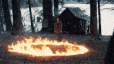 a man is standing in a circle of fire
