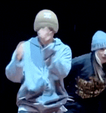 a man wearing a hat with the letter x on it is dancing