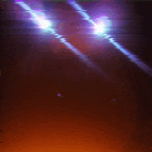 a purple light shines through a dark room