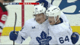 two toronto maple leafs players celebrate a goal