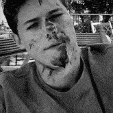a black and white photo of a young man with a stained face