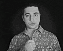 a man is wearing a shirt that says ari kani kani