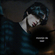 a man wearing a black shirt with moonjo de sael on it