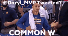 a man wearing a golden state warriors shirt is talking to someone in the crowd