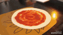 a pizza with tomato sauce on it is on a mat that says made in animatica