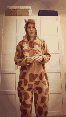 a woman in a giraffe costume is standing in front of a white wardrobe
