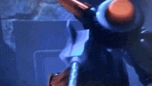 a robot is standing in a dark room with a sword in its hand .