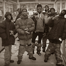 a group of people are posing for a picture in a black and white photo