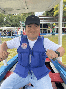 a man wearing a blue life vest that says ' jakarta ' on the front