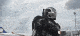 a man in an iron man suit stands in front of a plane
