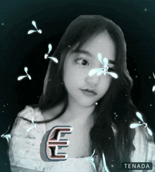 a black and white photo of a girl with a letter e on her face