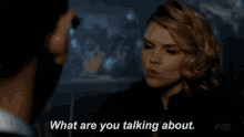 a man and a woman are talking to each other and the woman is asking the man what he is talking about .
