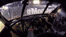 the inside of a race car with #monster on the windshield