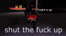 a red motorcycle with the words shut the fuck up on the bottom