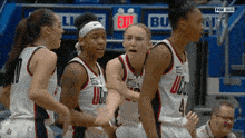 a group of female basketball players wearing jerseys with uconn on them