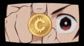 a close up of a person holding a coin with a letter c on it