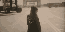 a woman wearing a black jacket that says ny on it